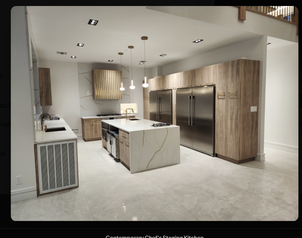 Contemporary chef’s staging kitchen with dual full-sized refrigerators and marble island